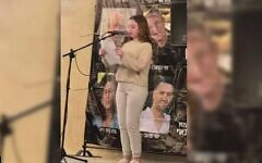 Former hostage Emily Hand speaks on May 21, 2025, at a Kibbutz Be'eri rally held for the hostages in the kibbutz's temporary quarters in Kibbutz Hazerim. (Courtesy Kibbutz Be'eri)